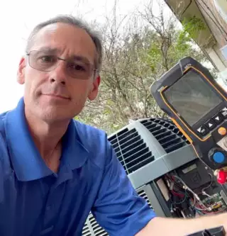 Wesley Ramirez repairs an air conditioning unit in Plano TX